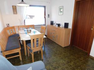 a room with a table and chairs and a kitchen at Ferienwohnung Krenzer in Ehrenberg