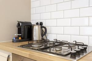 a stove top with a coffee pot on top of it at Percy Place - Modern 1 bedroom ground floor apartment in central Southsea, Portsmouth in Southsea
