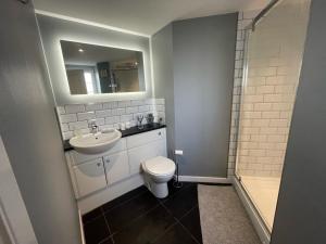 a bathroom with a toilet and a sink and a shower at Niche View in Irvine