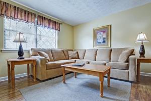 a living room with a couch and a coffee table at Mountain Meadows by Exploria Resorts in Pigeon Forge