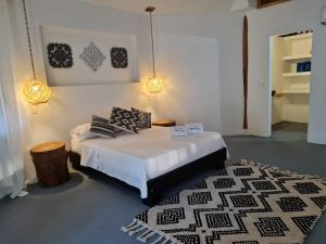 a bedroom with a bed and a black and white rug at Hotel Playa Mandala in Palomino