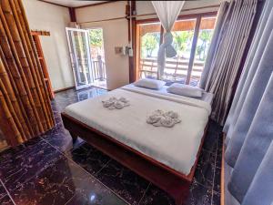 A bed or beds in a room at Pura Vita Resort