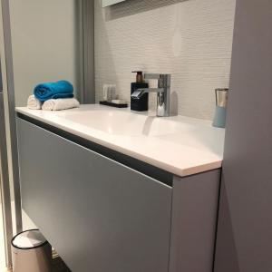 a bathroom with a white sink with a towel at Beach-la-Mar in Knokke-Heist