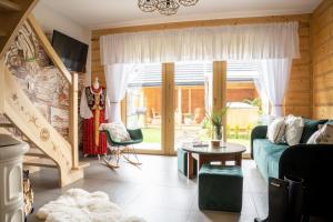 a living room with a couch and a table at Domek Chatka Góralki in Poronin
