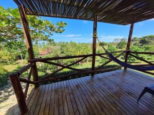 a wooden deck with a view of the forest at Hotel Playa Mandala in Palomino