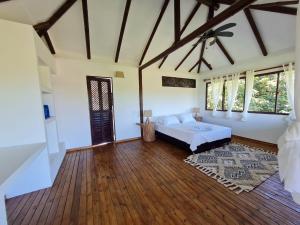 a large living room with a bed and a large window at Hotel Playa Mandala in Palomino