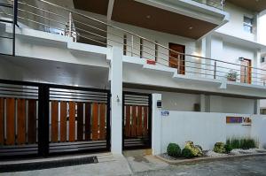 a building with two garage doors and a balcony at Bluewaves Westcliff Villa in Boracay