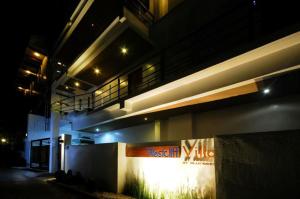 a building with a sign on the side of it at night at Bluewaves Westcliff Villa in Boracay
