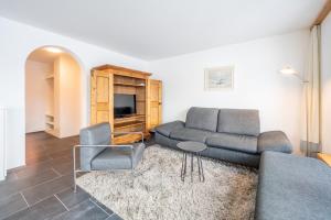 a living room with a couch and a tv at Casa Guarda Val 1 in Falera