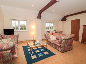 a living room with two couches and a coffee table at Lower Farm in Shaftesbury