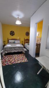 a bedroom with a bed and a rug on the floor at Guest House Boki da Zezé in Marau