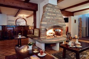 a large stone fireplace in a room with tables at Seilers Vintage Hotel & Spa in Kandersteg +157 photos