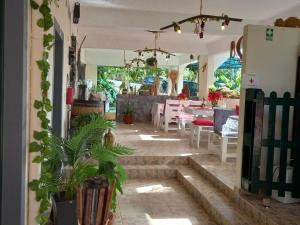 a room with a table and chairs and a refrigerator at Tabua Village Madeira Suite VIP in Ribeira Brava