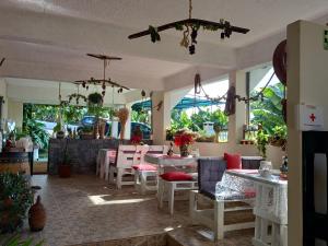 a restaurant with tables and chairs and windows at Tabua Village Madeira Suite VIP in Ribeira Brava +25 photos