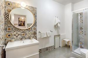 a bathroom with a sink and a mirror at Villa U Marchisi B&B in Scicli +9 photos