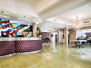 a lobby with a bar with a painting on the wall at Swan River Hotel in Perth