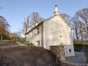 a small white building with a cross on top of it at Guardswood Cottage in Coniston