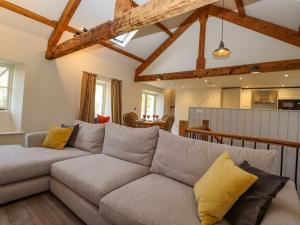 a living room with a couch and a table at Guardswood Cottage in Coniston