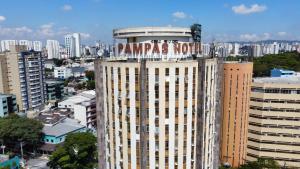 a large building with a sign on the top of it at Pampas Palace Hotel in São Bernardo do Campo