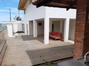 a patio with a red couch on top of a building at Pousada BarraVille in Barra Velha