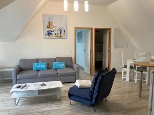 a living room with a couch and a table at La marine D'opale in Ambleteuse +187 photos