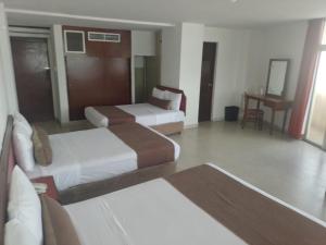 Postel nebo postele na pokoji v ubytování Hotel Royalty