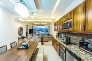 a kitchen with wooden cabinets and a counter top at 2031 - Barlovento 302 in Santa Cruz Huatulco