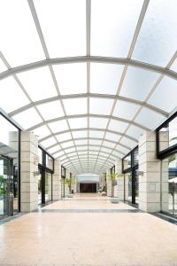 an empty building with a large glass ceiling at The Residential Suites Fukuoka in Fukuoka +39 photos