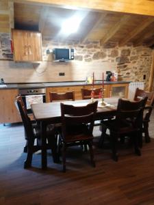 a kitchen with a wooden table and chairs at Fuinhas de Amor in Fornos de Algodres