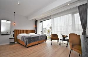 a bedroom with a bed and a large window at Patio Riverfront in Gdańsk