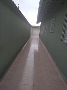 a hallway of a building with a tile floor at Linda casa ! in Mongaguá