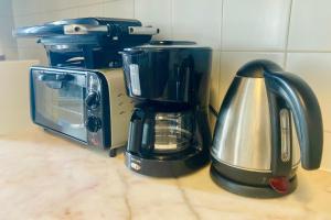 a kitchen counter with a coffee maker and a toaster at Apartamento Isabela - Baleal Island, 50m to the beach in Baleal