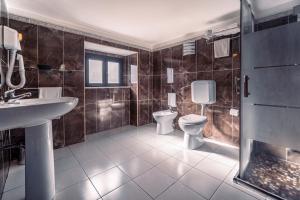 a bathroom with two toilets and a sink and a shower at Hotel Villa Romeo in Catania +36 photos