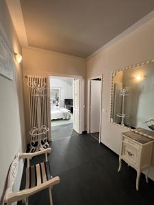 a room with a chair and a mirror and a bed at B&B Villa Prestigio in Novi Ligure +36 photos