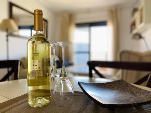 a bottle of wine sitting on top of a table at Regia Bahia en Cabo Roig in Orihuela Costa
