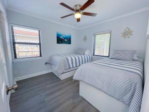 a bedroom with two beds and a ceiling fan at Great Stay in South Florida! -D-Centrally located in Miami