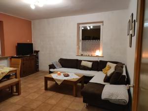 a living room with a couch and a table at Urlaub am Auberg in Gerolstein