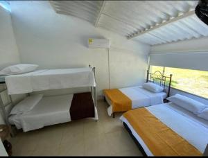 a room with two bunk beds and a window at LA FLORESTA ISLA DEL SoL in Prado +13 photos