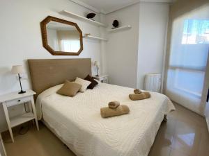 a bedroom with a bed with two towels on it at Regia Bahia en Cabo Roig in Orihuela Costa +28 photos