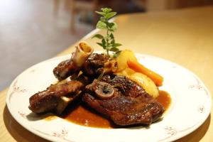 a plate of food with meat and vegetables on a table at Bankwirt in Schladming