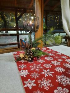 a table with a christmas table cloth with a lamp at Кафе-тратторія Городище in Nadvirna +7 photos