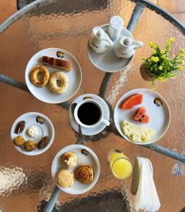a table with plates of breakfast foods and a cup of coffee at El Pantanal Hotel & Resort in San José de Chiquitos