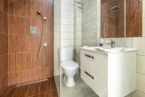 a bathroom with a toilet and a shower and a sink at Villa Pacyfic in Krynica Morska +43 photos