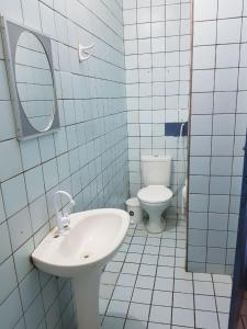 a bathroom with a sink and a toilet at Casa em Águas Belas CE in Águas Belas