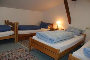 a bedroom with two beds with blue pillows on them at Beim Hanslbauer in Reit im Winkl