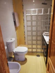 a bathroom with a toilet and a sink at Urbanlux Hospital II in Albacete