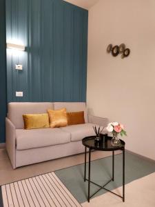 a living room with a couch and a table at the 6 apartments in Rimini