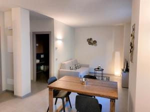 a living room with a wooden table and chairs at the 6 apartments in Rimini