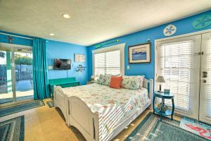 a bedroom with blue walls and a bed at Studio Steps to Beach and about 7 Miles to Pier Park! in Panama City Beach