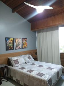 a bedroom with a bed and a ceiling fan at Summer Dream in Cabo Frio